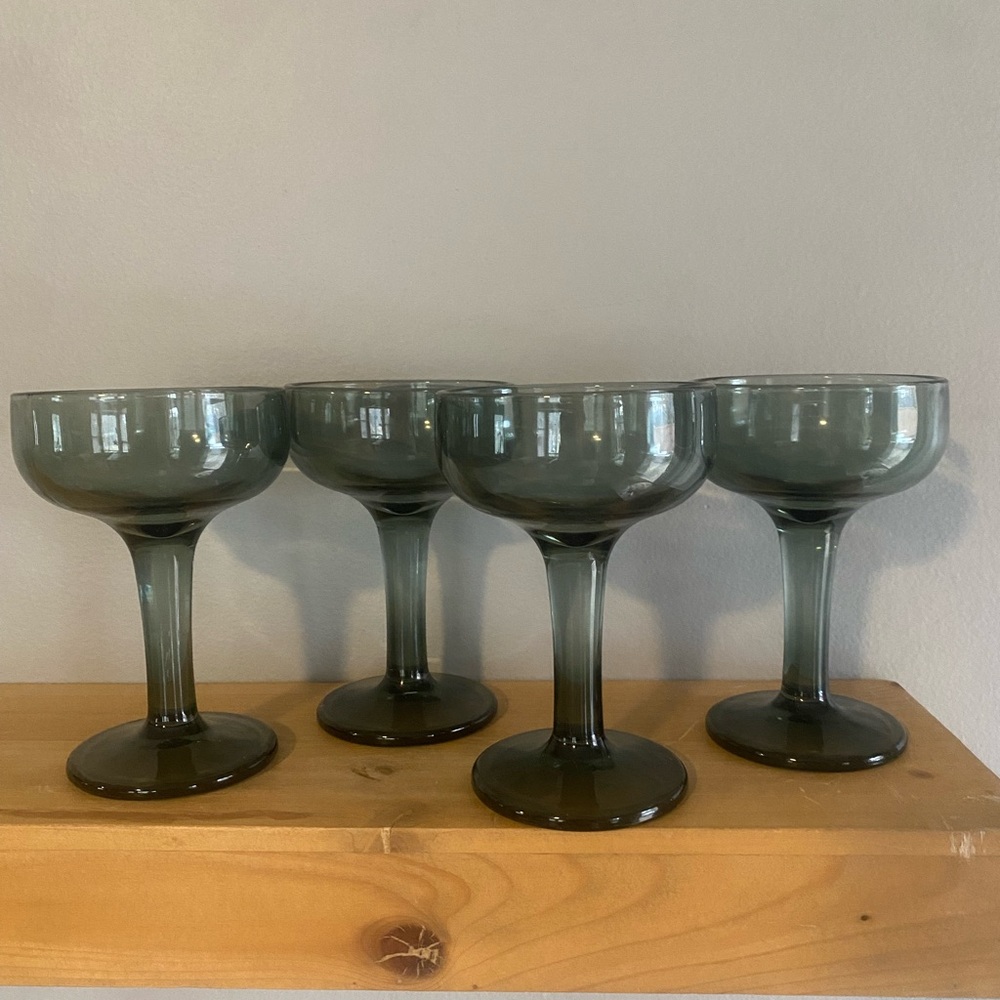 Vintage hand-blown smoky green coupe champagne cocktail glass.
